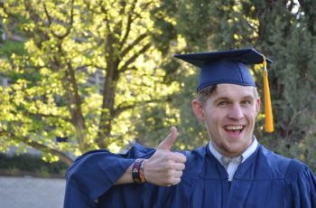 male college graduate in abue cap and gown