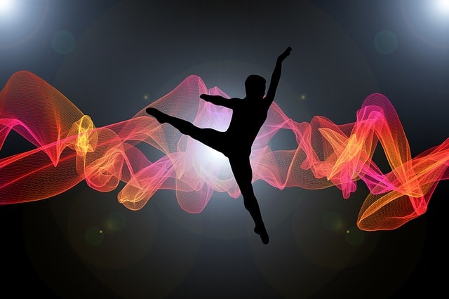 rnodern dance production with silhouette of dancer and lighted stage behind h im