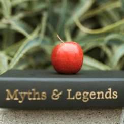 book of myths and legends with a apple on top